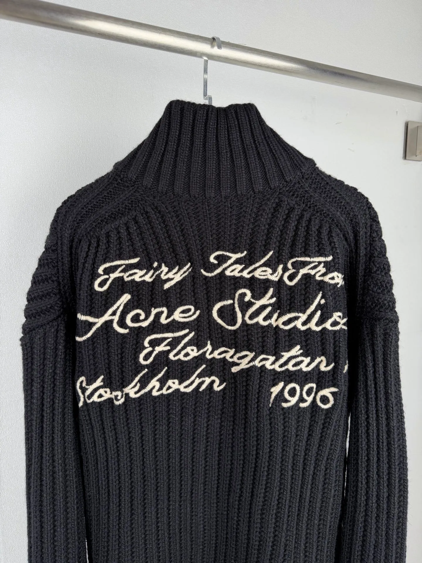 Acne Studios back embroidery zipper sweater jacket knitted sweater. Custom-woven mellow black woolen texture. Full texture, thick and solid. Every inch of fiber contains heavy warmth. The rich Black is used as the main color, exuding an irresistible charm. The vertical knitted lines on the front panel are more profound and three-dimensional. The exquisite zipper design is cleverly integrated into the knitted jacket, making the jacket instantly rejuvenated. The white embroidered logo on the back stands out on the black in an elegant manner, carrying the story and history of the brand. The heavy texture is everywhere showing its luxurious charm, showing a unique fashion attitude in minimalism. Process 1: Using imported machine embroidery technology, using advanced computer control systems and precision mechanical parts to realize Acne's seasonal embroidery logo work with high precision and smooth and delicate lines. Process 2: Softening and deodorizing process of ready-made clothes through professional washing equipment and specific detergents. Deep clean and deodorize clothes Improve the feel and appearance of clothes Accessories: Customized 1:1 Acne zipper Customized 1:1 Acne trademark Fit: Loose fit Size: S M L XL